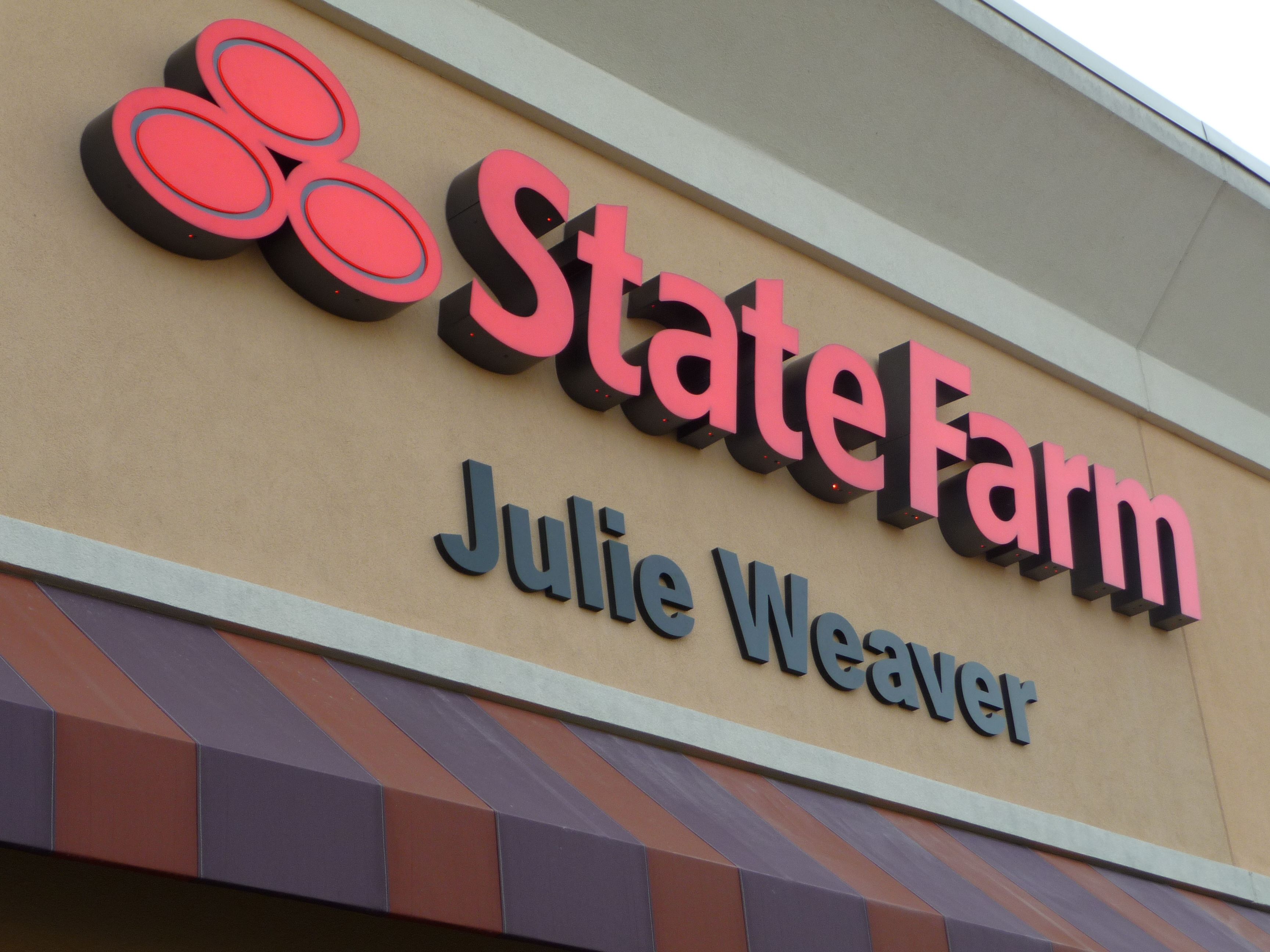 Storefront sign with 3D channel letters promoting insurance agency